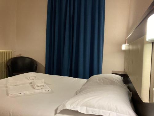 Un ou plusieurs lits dans un hébergement de l'établissement Hôtel Le Florin