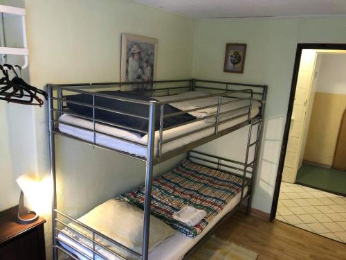 two bunk beds in a room with a mirror at U Szermierzy in Wrocław
