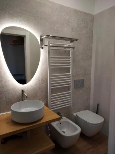 a bathroom with a sink and a toilet and a mirror at La Villa bed & breakfast in Milan