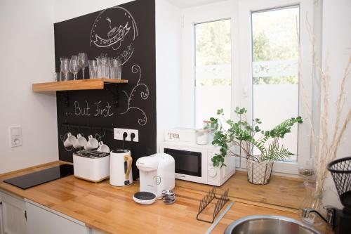 a kitchen with a counter top with a microwave at Bíborlak in Villány