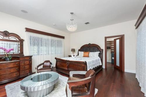 a bedroom with a bed and a glass table at Villa Toscana - Luxury with Pool in Miami