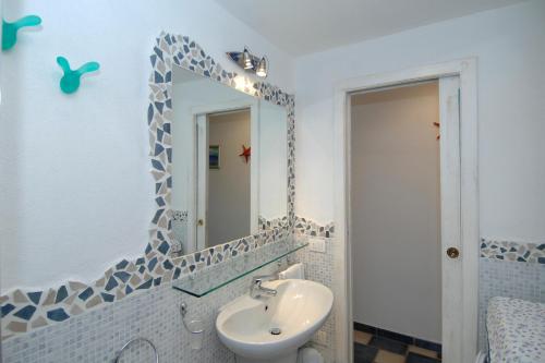 a bathroom with a sink and a mirror at Sardegna Beach Eucalyptus in Golfo Aranci