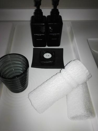 a white towel on a counter next to a plate and bowls at Clouds Estate in Stellenbosch