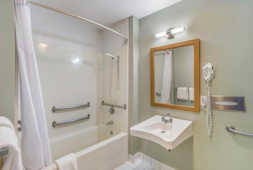 a bathroom with a shower and a sink and a shower at Quality Inn & Suites Gorham Riverside in Gorham