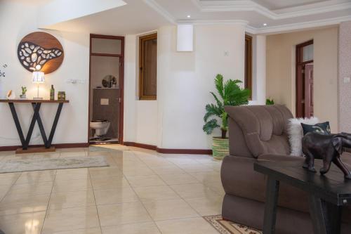 a living room with a couch and a table at ZaNaKri Homes ;A Great Panorama of Indian Ocean in Mombasa