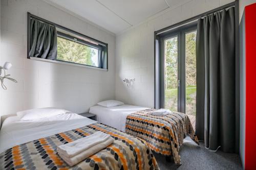 Postel nebo postele na pokoji v ubytování Kääriku Team Cabin
