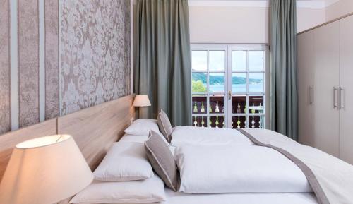 Säng eller sängar i ett rum på Lust und Laune Hotel am Wörthersee