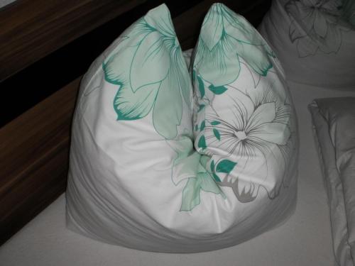 a white cake with green flowers on it at Appartement Tiefenbrunn in Auffach