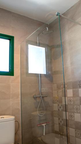 a shower with a glass door in a bathroom at VILLA SEA&SKY - spectacular 180 degree ocean views in Puerto del Carmen