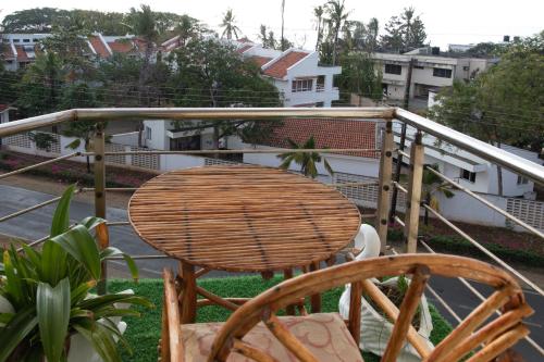 a rattan table and chairs sitting on a balcony at ZaNaKri Homes ;A Great Panorama of Indian Ocean in Mombasa