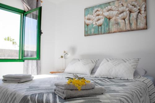 a bedroom with a bed with towels on it at VILLA SEA&SKY - spectacular 180 degree ocean views in Puerto del Carmen