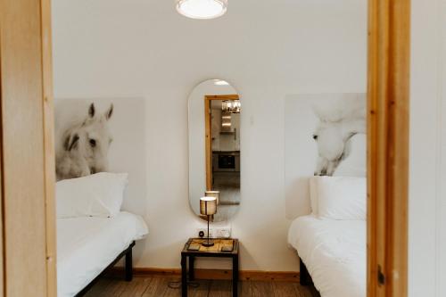 a bedroom with two beds and a mirror at FAIRVIEW FARM Holiday Accommodation 14 Luxury Lodges, Cabins, Dog Friendly, Suitable for Couples, Families and Groups, Wedding Guests , Corporate events, Sleeps 2-65 guests in Ravenshead, Nottingham near Sherwood Forest, set in 88 acres in Nottingham