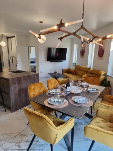 a dining room with a table and chairs at Baltic Sun Apartament in Pobierowo