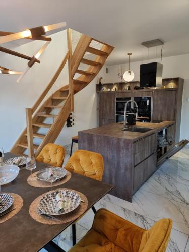 a kitchen and dining room with a table and chairs at Baltic Sun Apartament in Pobierowo