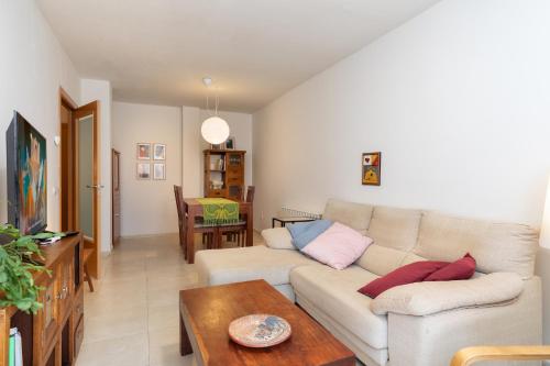 a living room with a couch and a table at Hauzify I Apartament Capmany in Sant Feliu de Guíxols