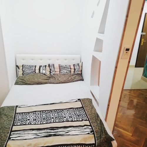 a small room with a bed and a staircase at Marina Jacuzzi Apartment free parking in Novi Sad