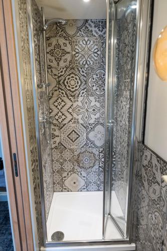 a shower with a glass door next to a tile at Royal Oak in Dover