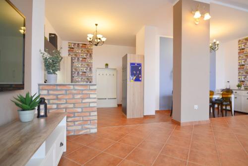 a kitchen and living room with a brick wall at Villa Concha-Apartamenty Bryza-Parking in Świnoujście