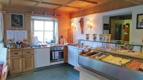 a large kitchen with a counter and a counter top at Bio & Reiterhof der Veitenhof in Umhausen