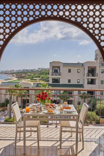 a table and chairs on a balcony with a view at Four Seasons Hotel Tunis in Gammarth