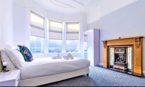 a bedroom with a large bed with a fireplace at Queen’s Stay in Liverpool