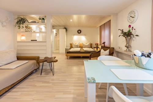 a living room with a couch and a table at Haus Behr am See Nr 2 in Radolfzell am Bodensee
