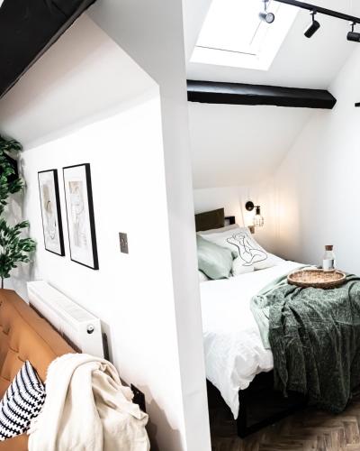 a white bedroom with a bed and a couch at Urban Loft Apartment • 1 Bedroom • Manchester in Ashton under Lyne