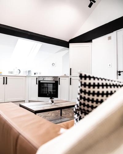 a living room with a couch and a coffee table at Urban Loft Apartment • 1 Bedroom • Manchester in Ashton under Lyne