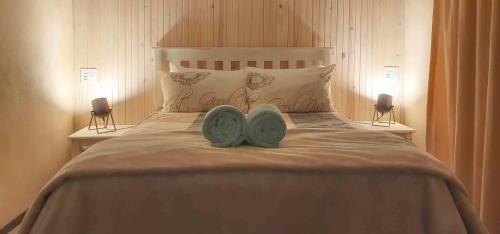 a bedroom with a bed with two shoes on it at Fourfields Cottage in Hogsback