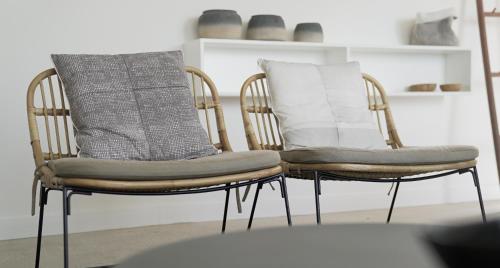 two chairs with pillows on them in a room at Casagrande Hotel & Beach Club in José Ignacio