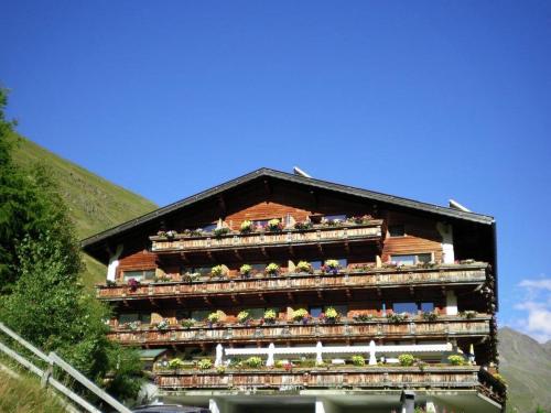 a building with plants on the balconies of it at Gasthof Geierwallihof Klotz Konrad KEG in Vent