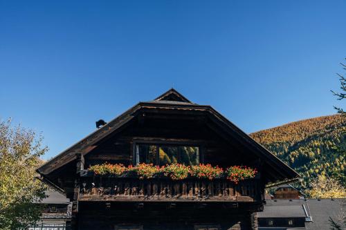 a house with a balcony with flowers on it at Beim Oswald in Bad Kleinkirchheim