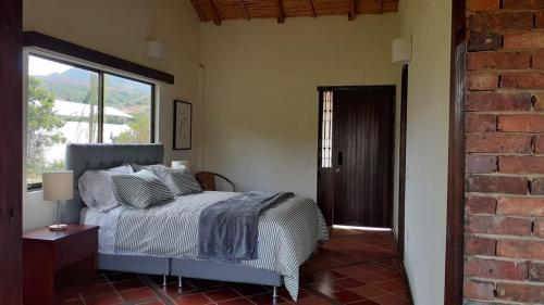 a bedroom with a bed and a large window at Hotel Suamena in Ráquira
