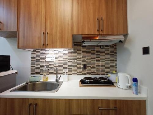 a kitchen with a sink and a counter top at Antara Residentials and Condominium in Talisay