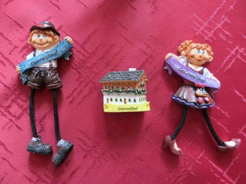 three toy figurines are hanging on a wall at Gasthof Geierwallihof Klotz Konrad KEG in Vent
