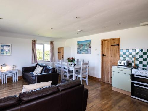 a living room with a couch and a table at Harbour Lodge in Port Isaac