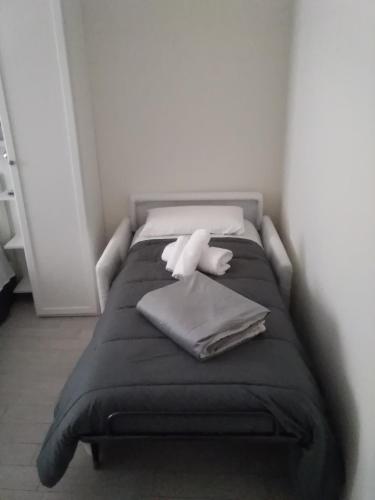 a bed with a white stuffed animal sitting on it at La Casa di Ludovica all'Appio Latino in Rome
