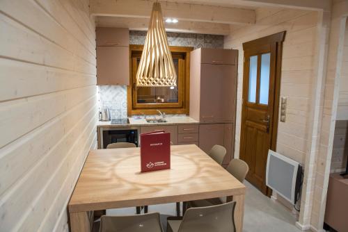a kitchen with a table with a book on it at Górskie Wytchnienie in Jelenia Góra