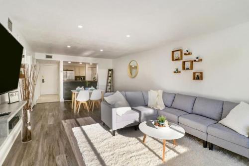 a living room with a blue couch and a table at Saddlebrook Gem private condo with Kitchen in Wesley Chapel