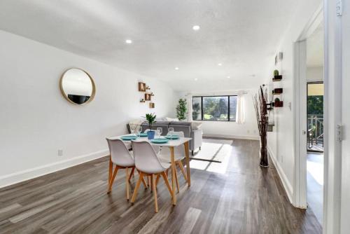a dining room and living room with a table and chairs at Saddlebrook Gem private condo with Kitchen in Wesley Chapel