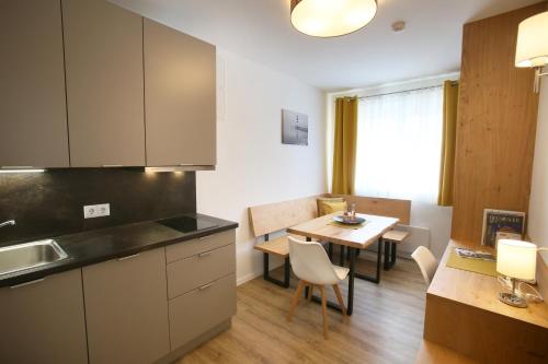 a kitchen and dining room with a table at Apartments Freitag - H1 in Winden am See