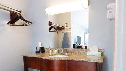 a bathroom with a sink and a mirror at Sunrise Inn Williamstown in Williamstown