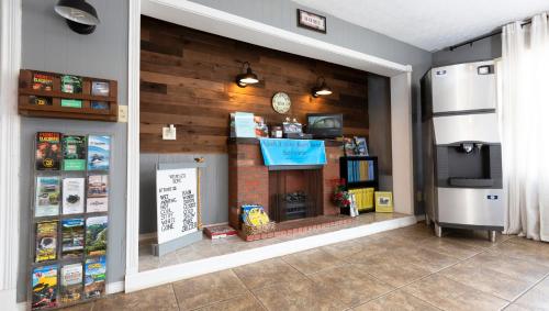 a store with a fireplace and a clock on the wall at Sunrise Inn Williamstown in Williamstown