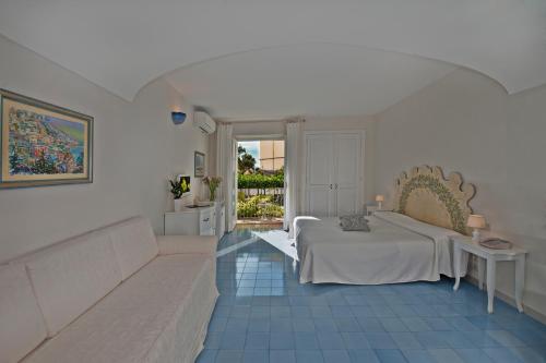 a living room with a bed and a couch at Villa La Tartana in Positano