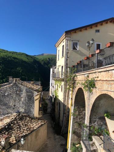 an old stone building with an archway in a city at B&B Casa Mila' in Pretoro
