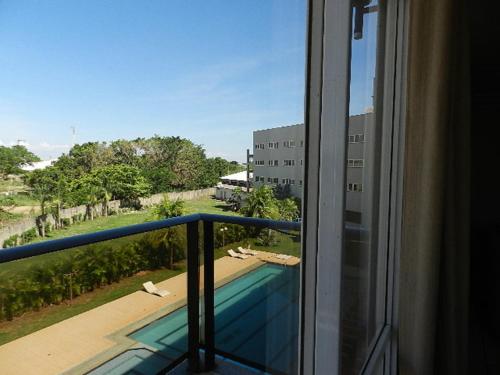 a balcony with a view of a swimming pool at Hits Pantanal Hotel in Várzea Grande