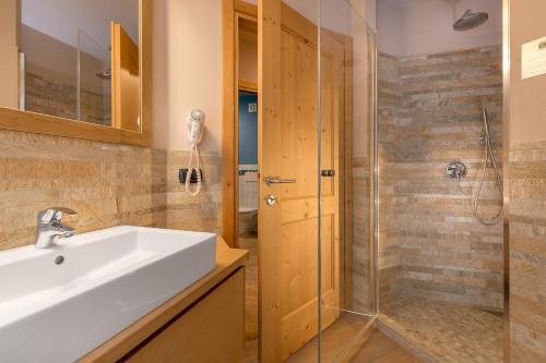 a bathroom with a sink and a shower at Hotel San Lorenzo in Bormio