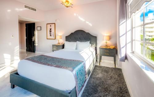 a bedroom with a large bed and a window at Secret Garden Miami Beach in Miami Beach