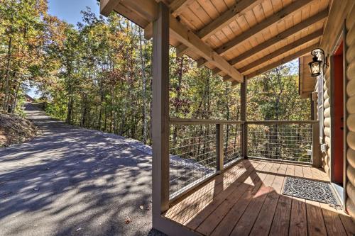 a porch of a house with a wooden deck at Pigeon Forge Cabin with Hot Tub 1 Mi to Parkway in Pigeon Forge