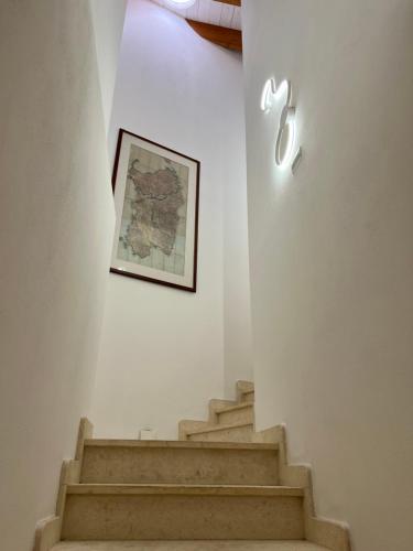 an apple sign on a wall next to stairs at L’ANGELO BIANCO 2 in Pula